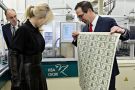 People analysing printed money