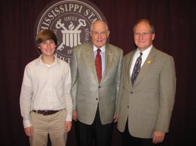 three men smiling for a photo