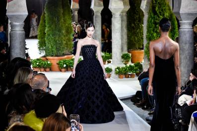 woman in a dress walking in a show